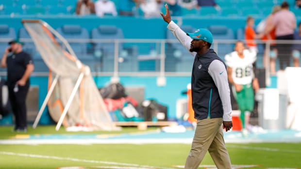 Miami Dolphins head coach Brian Flores waves at fans after winning the game against the New York Jets at Hard Rock Stadium.